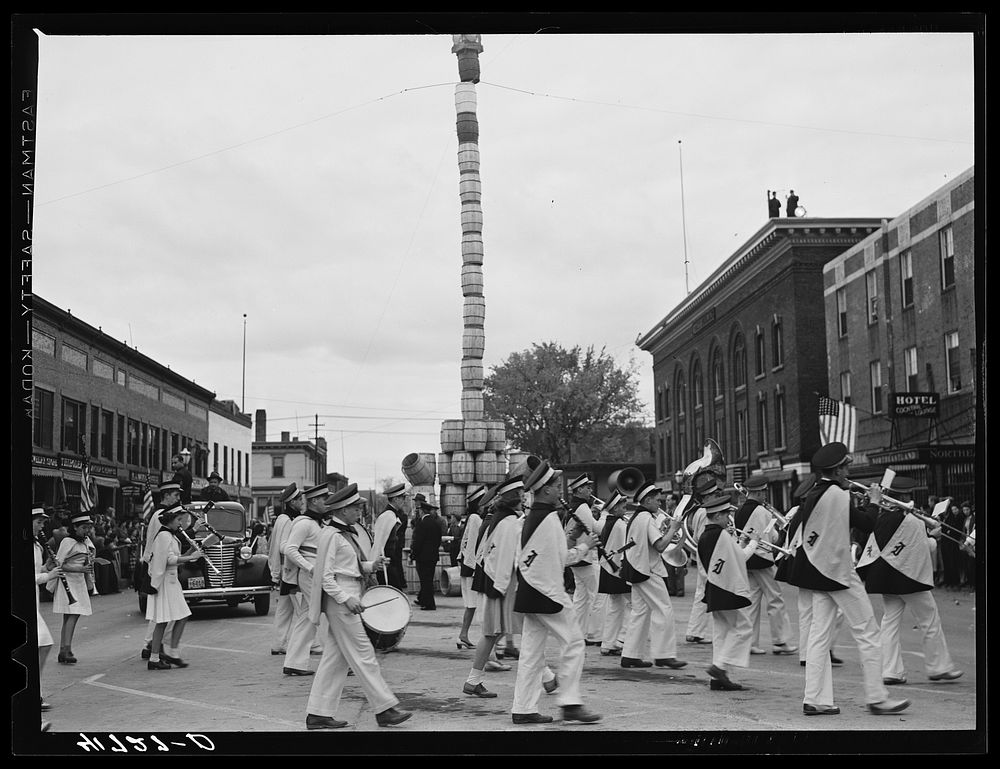 The school band parading on the main street of Presque Isle, Maine, in celebration of the barrel rolling contest. Sourced…