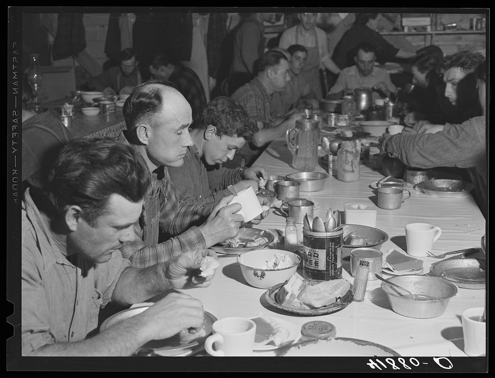 Lunch hour at one of the farms of the Woodman Potato Company. All of the pickers and field laborers eat in this converted…