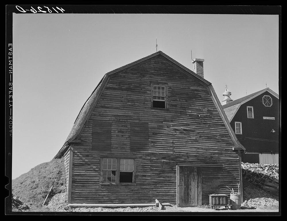 [Untitled photo, possibly related to: Potato storage barn on a field near Caribou, Maine. The earth is built up around the…