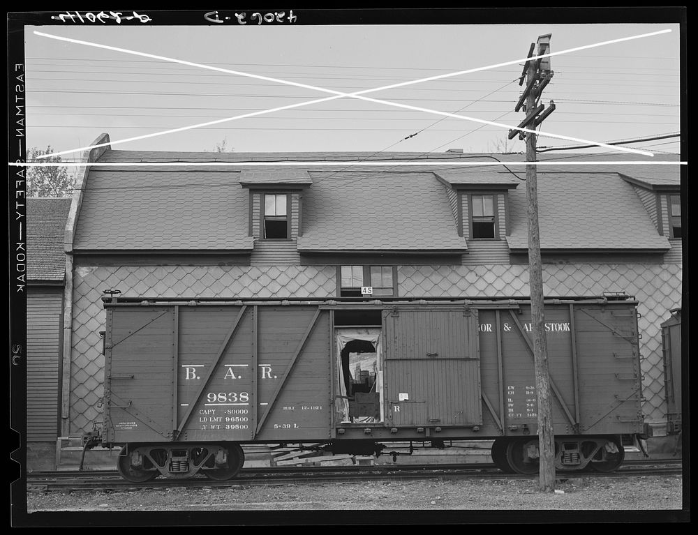 A car of the Bangor and Aroostook Railroad at one of the potato storehouses in Caribou, Maine. Sourced from the Library of…