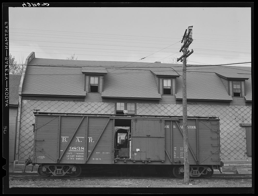 [Untitled photo, possibly related to: A car of the Bangor and Aroostook Railroad at one of the potato storehouses in…