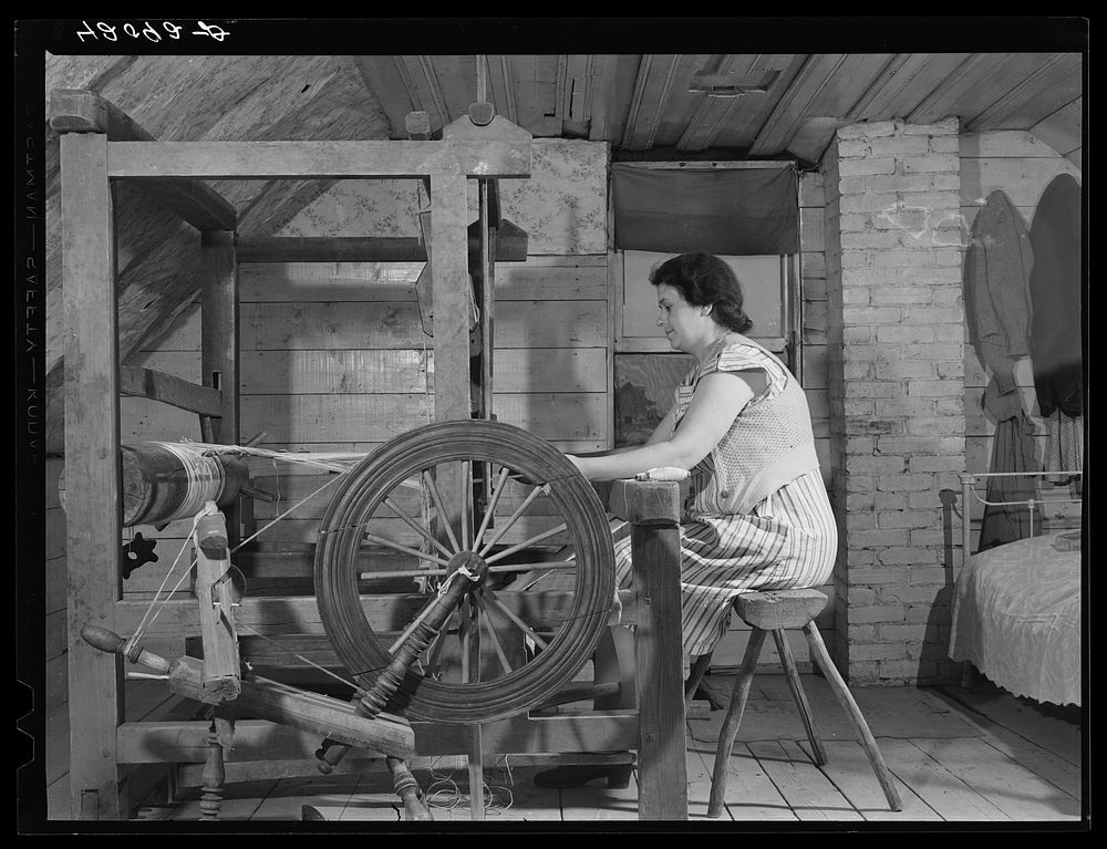 Mrs. Patrick Dumond, weaving toweling on a old loom in the attic. The Dumonds are French-Canadians and run a small farm in…