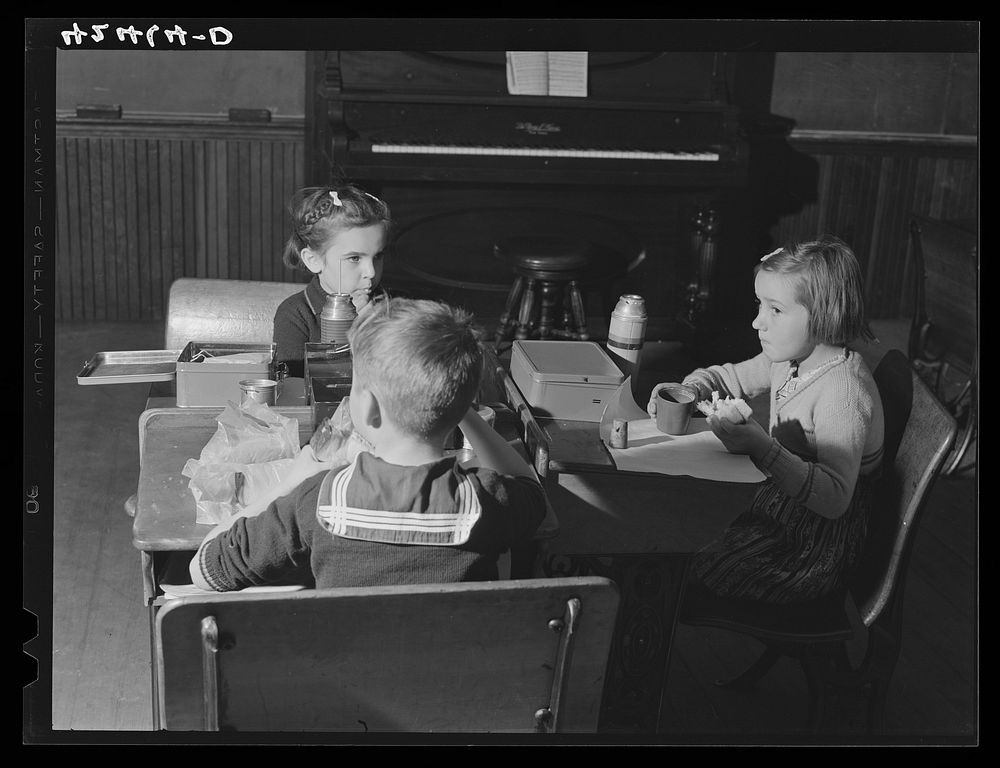 [Untitled photo, possibly related to: Children having lunch in the schoolhouse in Ledyard, Connecticut]. Sourced from the…