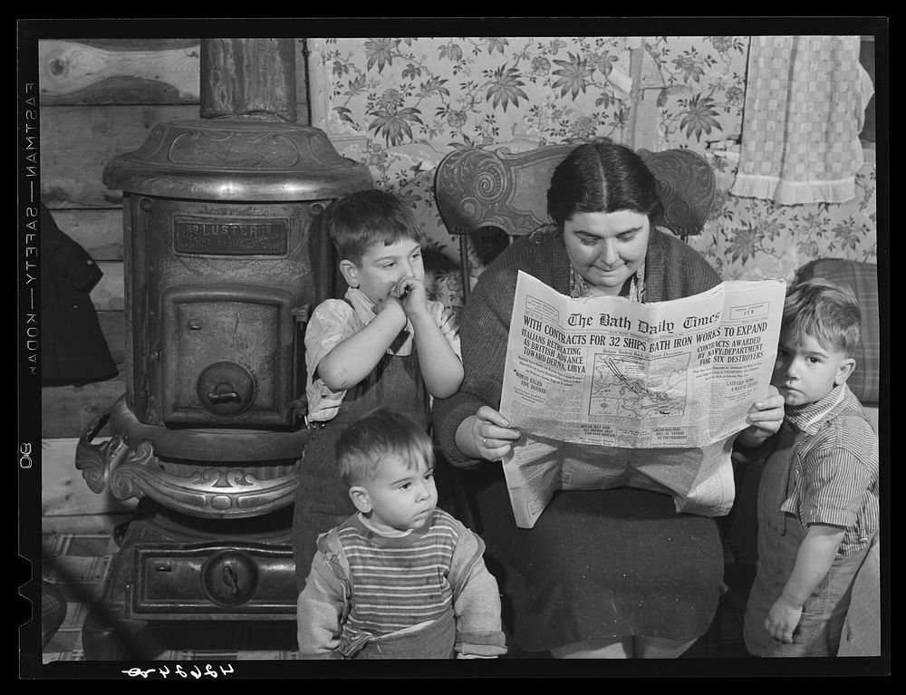 Mrs. Arthur Brown with three of her children reading Bath Daily Times. The husband works at the shipyard. After having been…