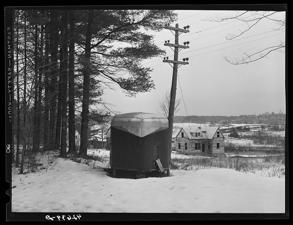 A trailer and a new house being built along the highway about a mile outside of Bath, Maine. Sourced from the Library of…