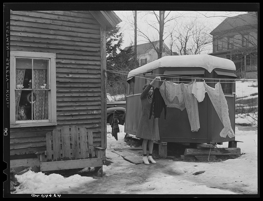 Mrs. Avery Hamblen, young wife of a shipyard worker hanging out wash in front of her trailer, where the two of them have…