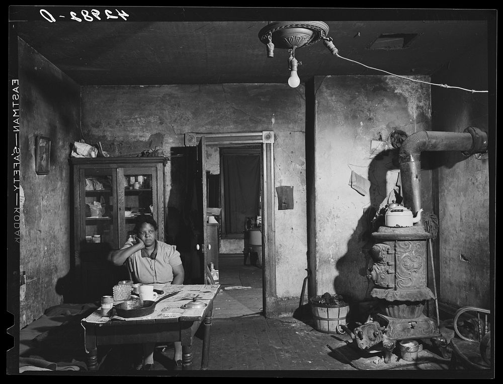  woman in a dilapidated house in the Mount Washington district of Beaver Falls, Pennsylvania. Sourced from the Library of…