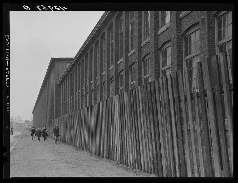 Outside a large textile mill in New Bedford, Massachusetts. Sourced from the Library of Congress.