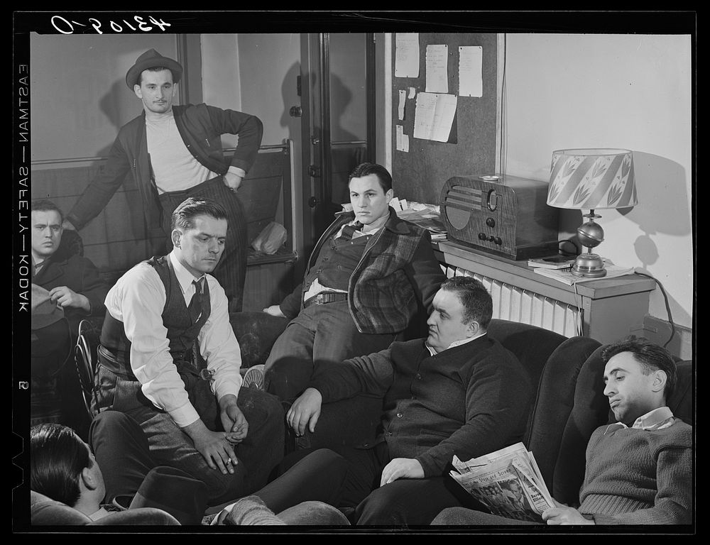 Steelworkers of the Serbian Club listening to the Joe Louis fight at their club headquarters in Aliquippa, Pennsylvania.…