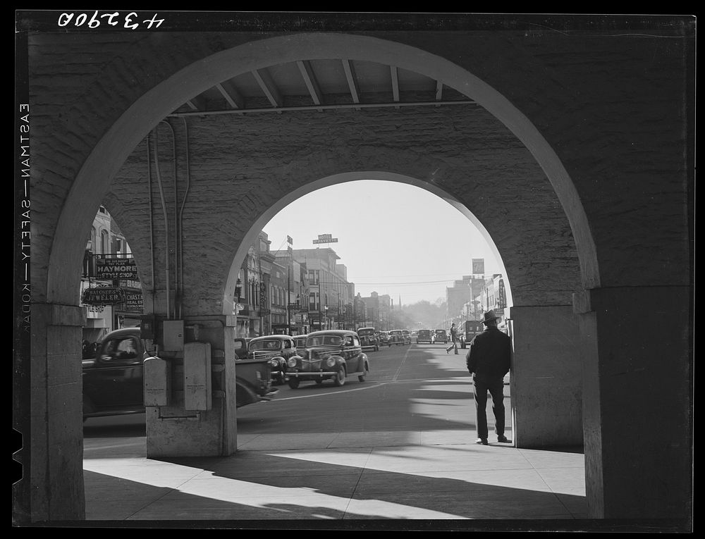 [Untitled photo, possibly related to: Traffic on the main street of Fayetteville, North Carolina at about five o'clock, when…