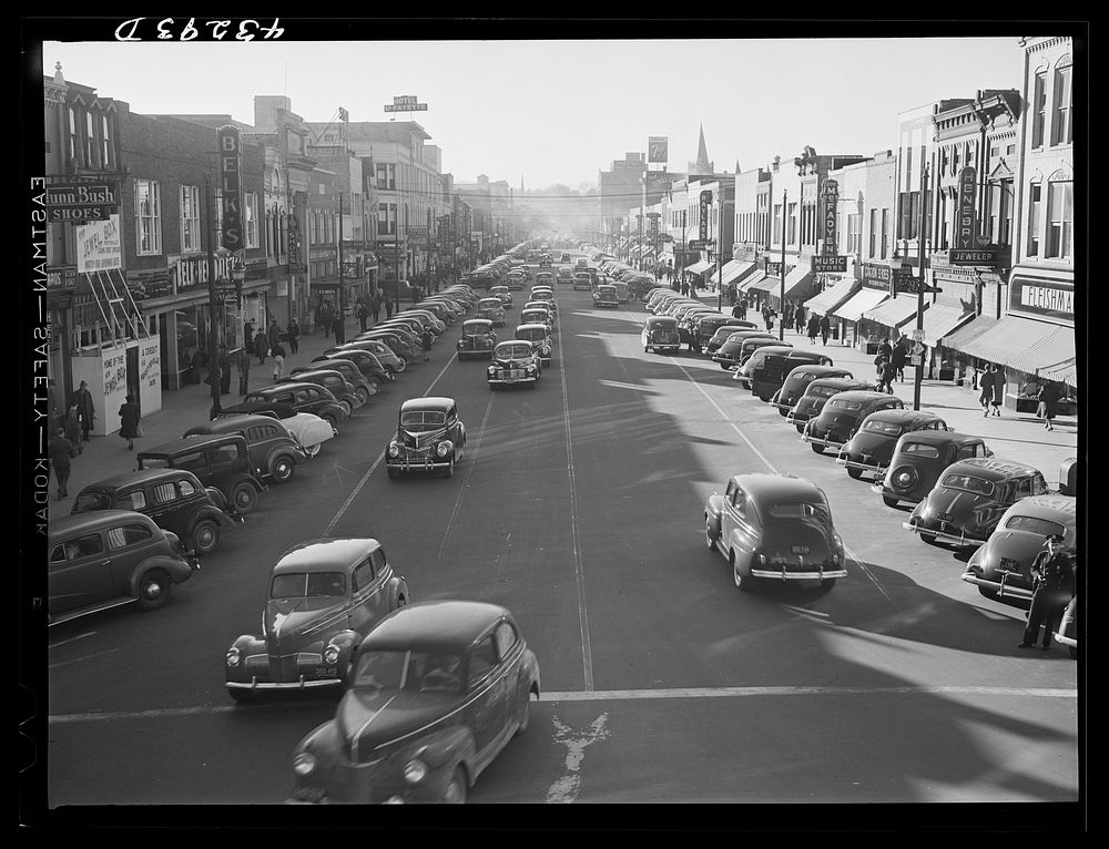 [Untitled photo, possibly related to: Traffic on the main street of Fayetteville, North Carolina at about five o'clock, when…
