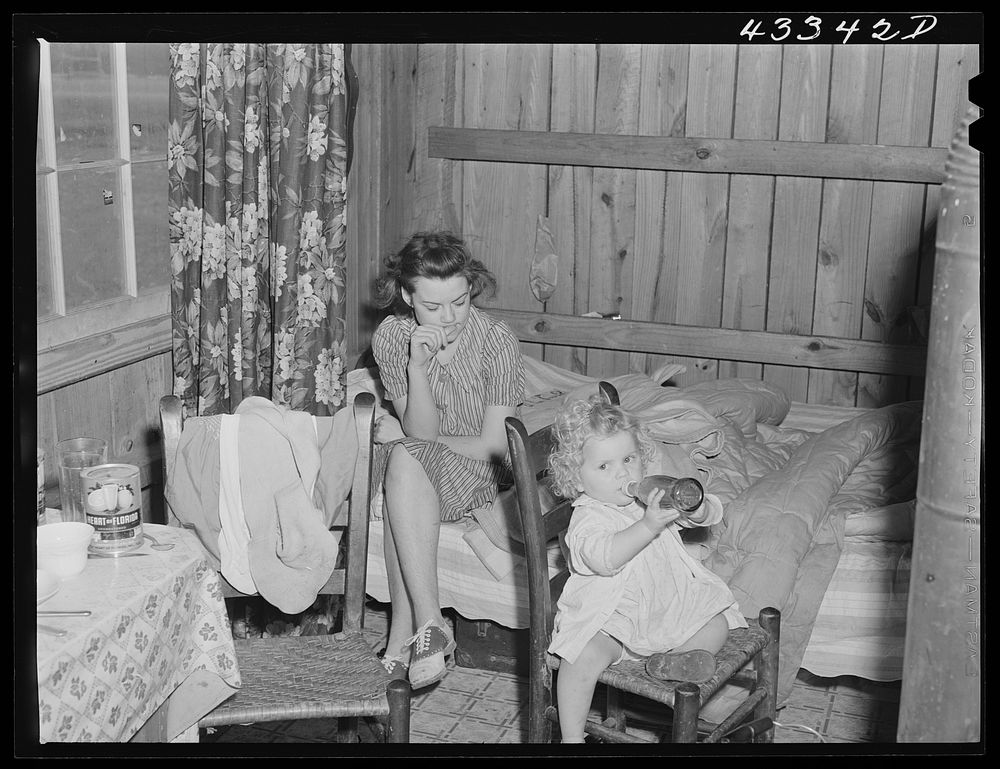 In the second story of tobacco barn used as living quarters by family of workers from Fort Bragg, North Carolina, near…