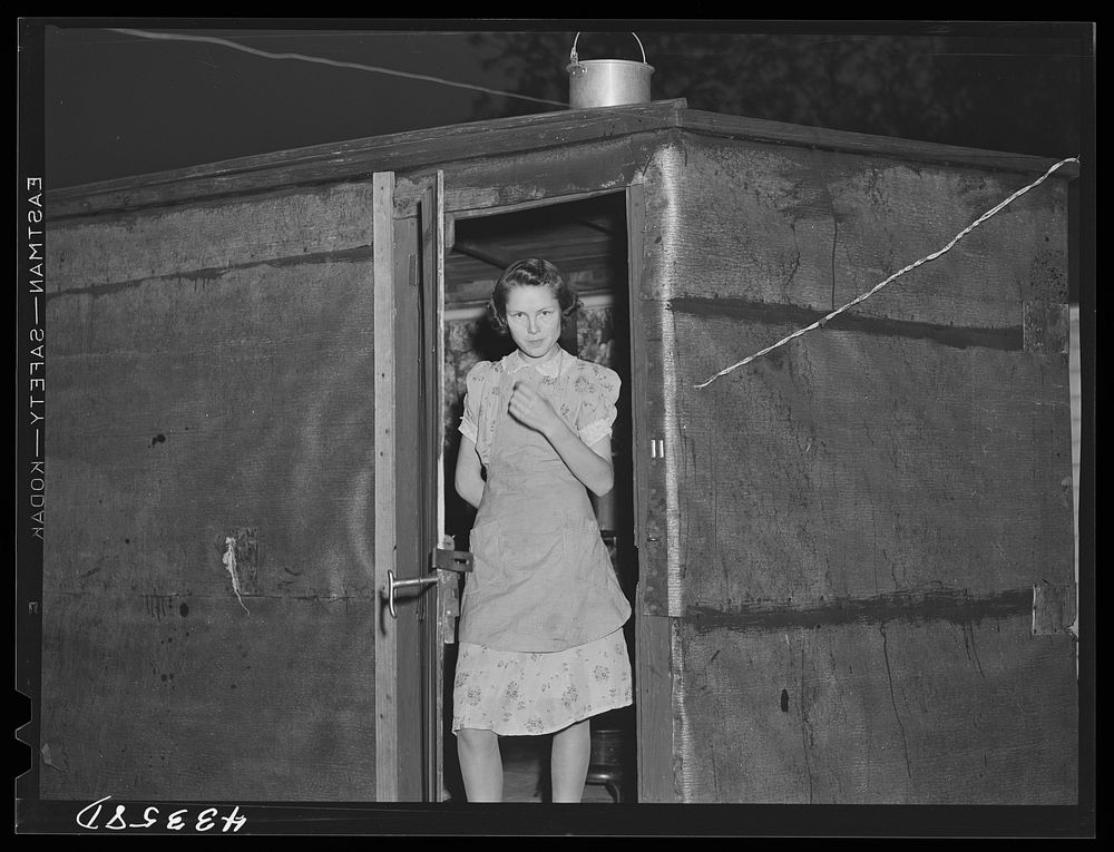 [Untitled photo, possibly related to: Young girl lives in this shack with her husband who works at Fort Bragg.  In a…