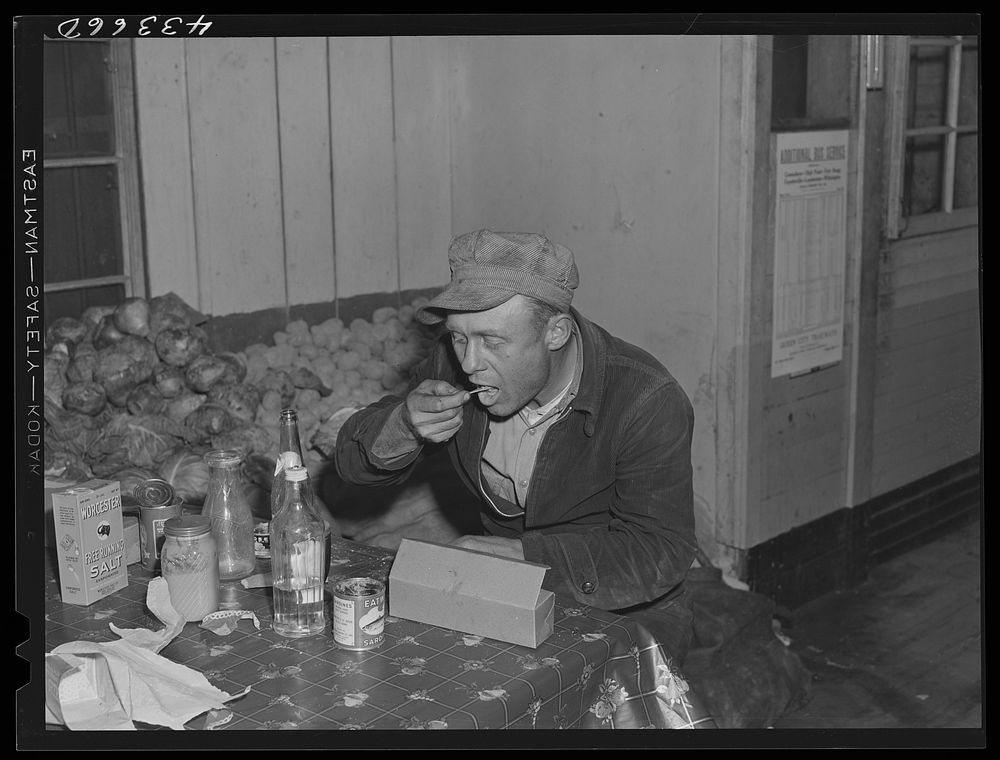 Worker from Fort Bragg having his dinner at a crossroads store in Manchester, North Carolina. Sourced from the Library of…
