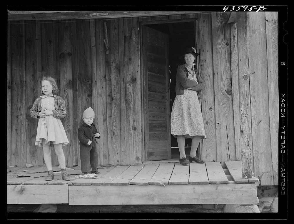 [Untitled photo, possibly related to: A tenant family in the Camp Croft area watching their belongings being moved out. Near…