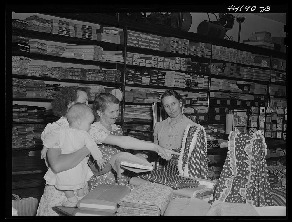 Saturday afternoon shoppers in the Bickers Goodwin store in Greensboro. Greene County, Georgia. Sourced from the Library of…