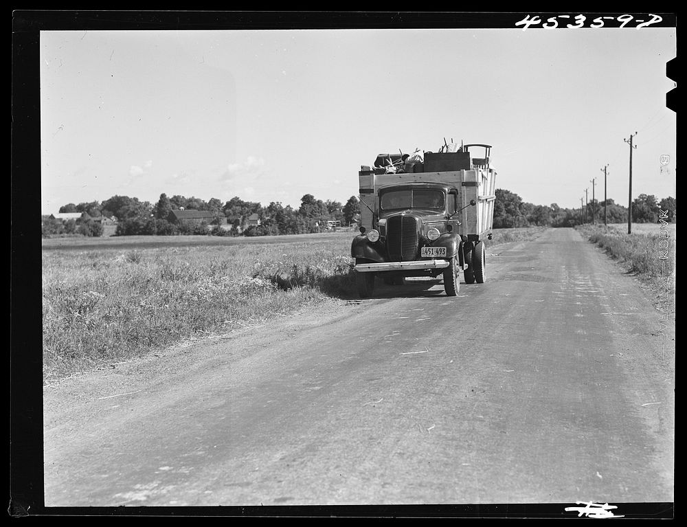 A truck on the road in the Pine Camp expansion area moving out a family's belongings. New York. Sourced from the Library of…