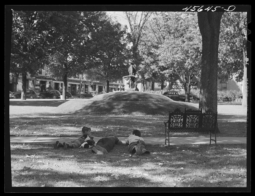 Boys lounging in the square in Enosburg Falls, Vermont. Sourced from the Library of Congress.