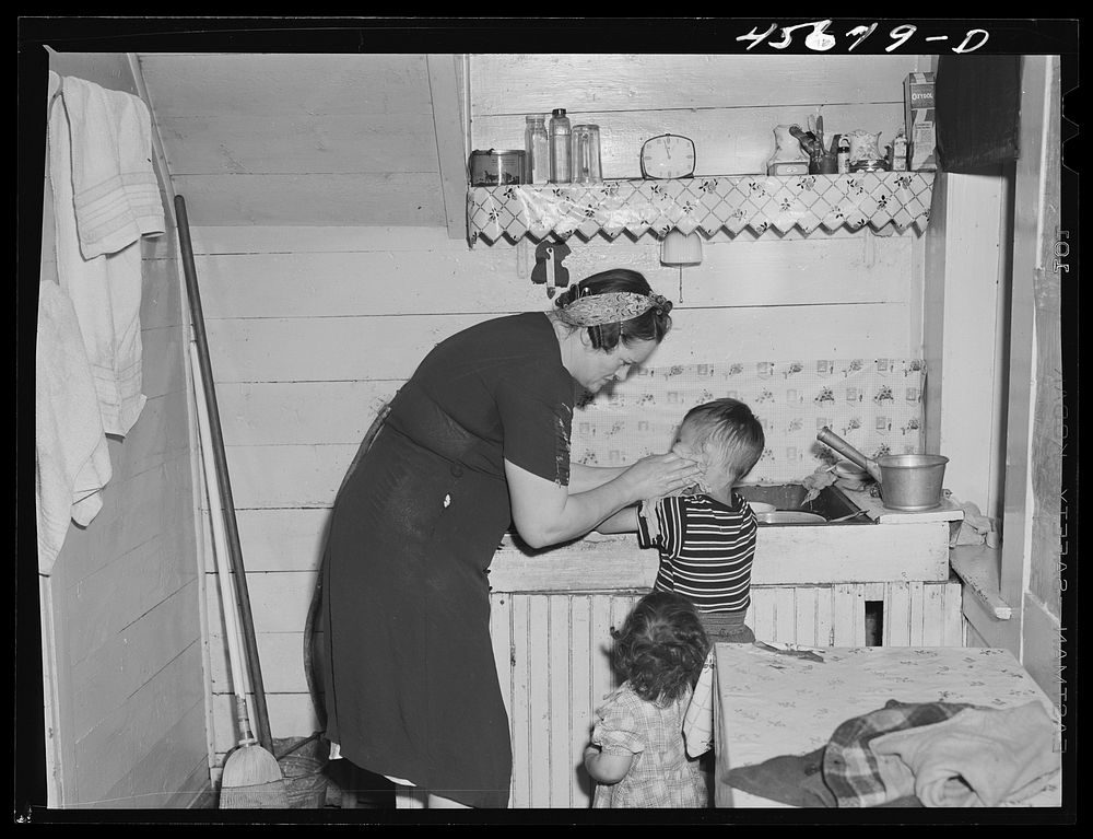 Mrs. Gaynor scrubbing the children's faces before dinner on their farm near Fairfield, Vermont. Sourced from the Library of…