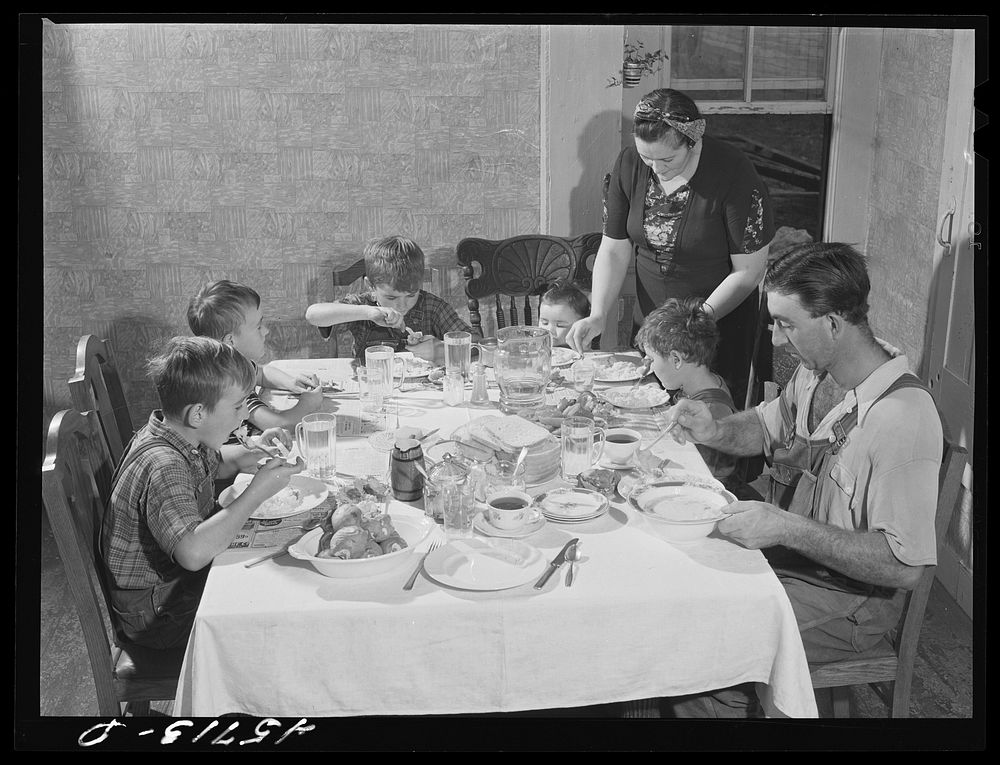 The Gaynor family at dinner on their farm. Fairfield, Vermont. Sourced from the Library of Congress.