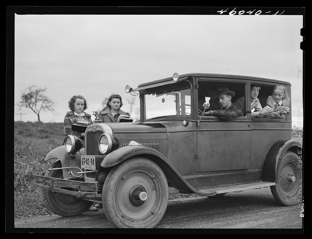 Children of Dan Sampson, who moved out of the Pine Camp expansion area in August, waiting in the family car for the school…