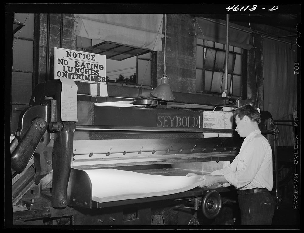 Trimming paper at the Mississquoi Corporation paper mill in Sheldon Springs, Vermont. Sourced from the Library of Congress.