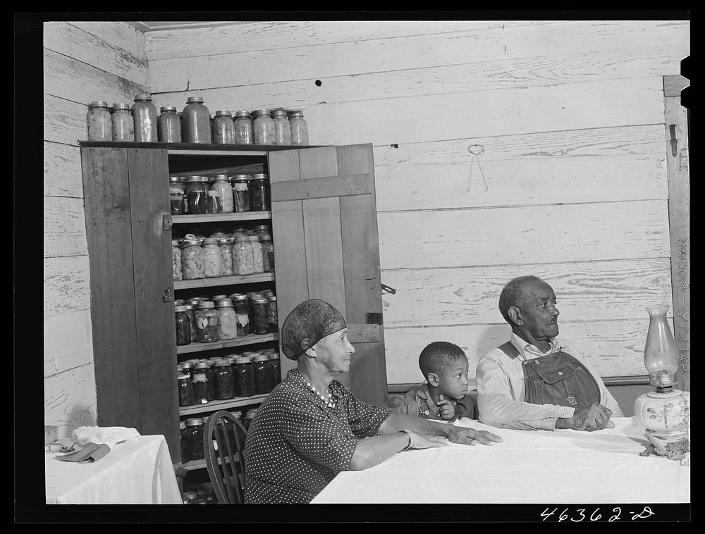 [Untitled photo, possibly related to: George Ward and his wife and one of his five children with some of their canned goods.…