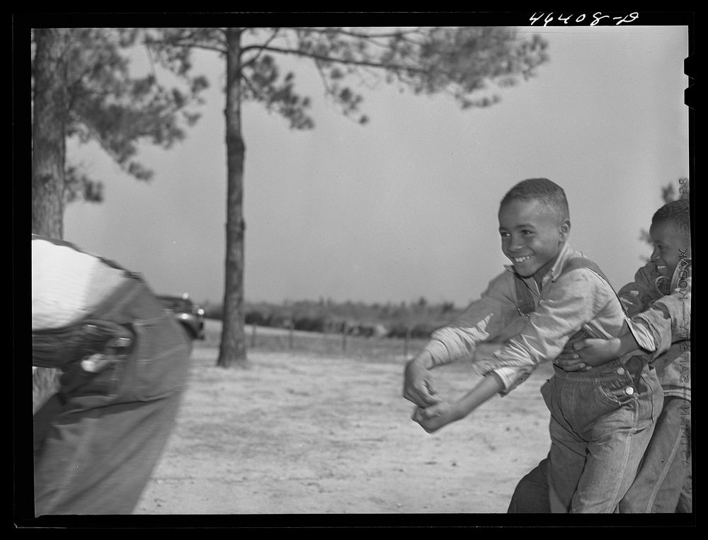 [Untitled photo, possibly related to: Boyd Jones, playing tug-of-war with class mates during play period at the Alexander…