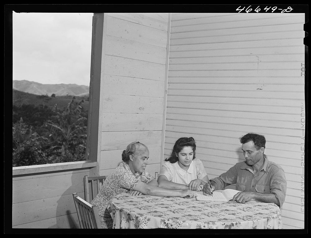 Barranquitas, Puerto Rico. FSA (Farm Security Administration) tenant purchase farmer and his wife working on their record…