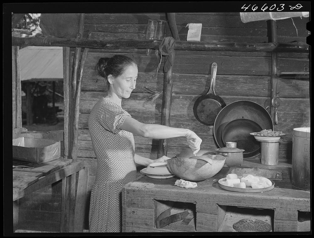 Manati (vicinity), Puerto Rico. Wife of a FSA (Farm Security Administration) borrower preparing lunch in their home. Sourced…