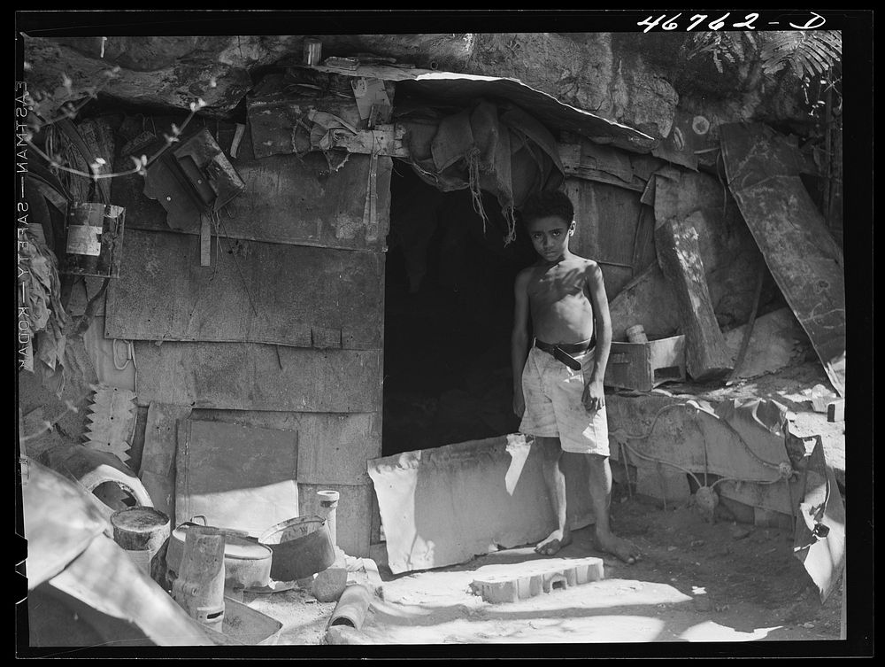 Ponce, Puerto Rico. A cave in slum area in which two people live. Sourced from the Library of Congress.