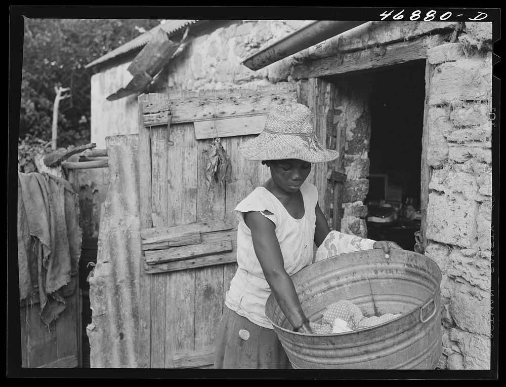 Saint Croix Island, Virgin Islands. Woman washing clothes in the slum village of Saint Johns. Sourced from the Library of…