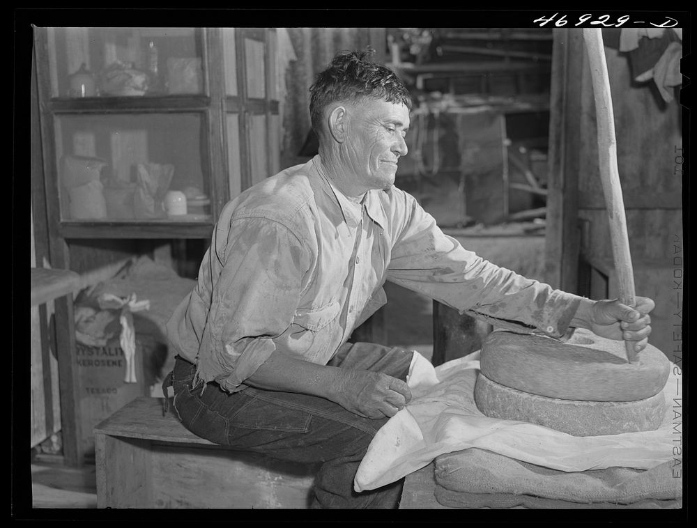 Frederiksted (vicinity), Saint Croix Island, Virgin Islands. Puerto Rican farmer grinding corn with stones he brought with…