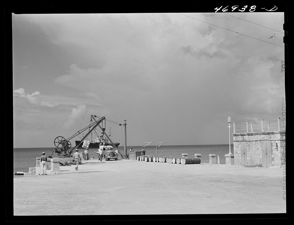 Frederiksted, Saintt Croix Island, Virgin Islands. Loading cargo on a freighter in the harbor. Because there is no pier, the…