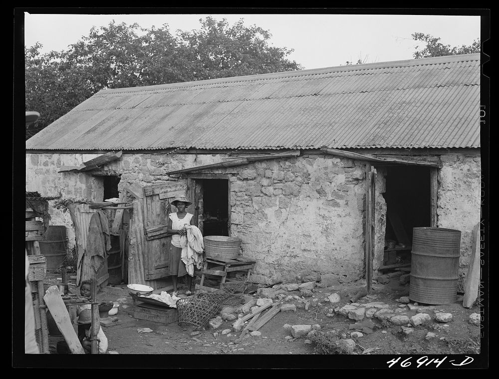 Saint John, Saint Croix Island, Virgin Islands. Village house divided off into rooms, one for each family. Sourced from the…