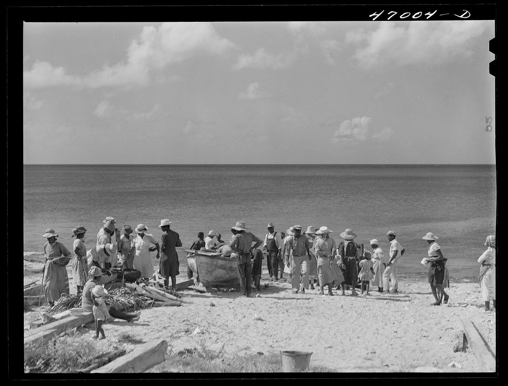Frederiksted, Saint Croix Island, Virgin Islands. Housewives at the seashore waiting for the fishing boats to come in.…