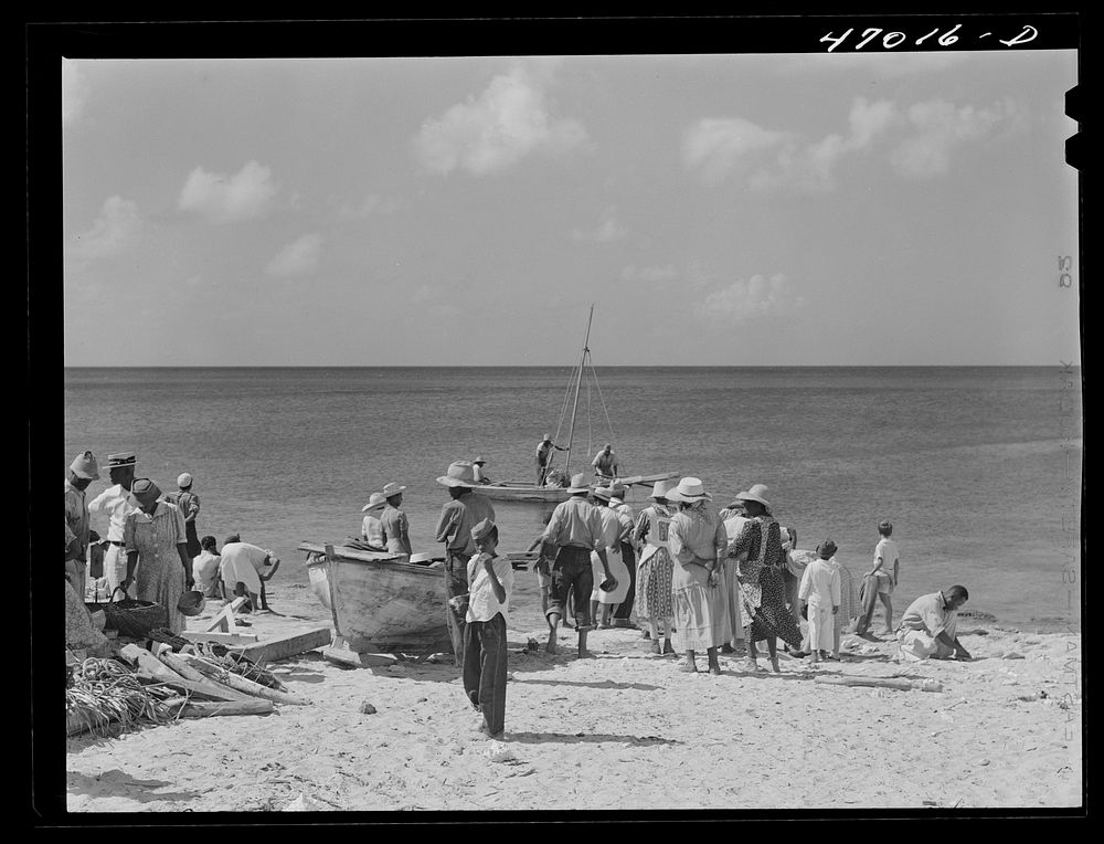 Frederiksted, Saint Croix Island, Virgin Islands. Housewives at the seashore waiting for the fishing boats to come in.…