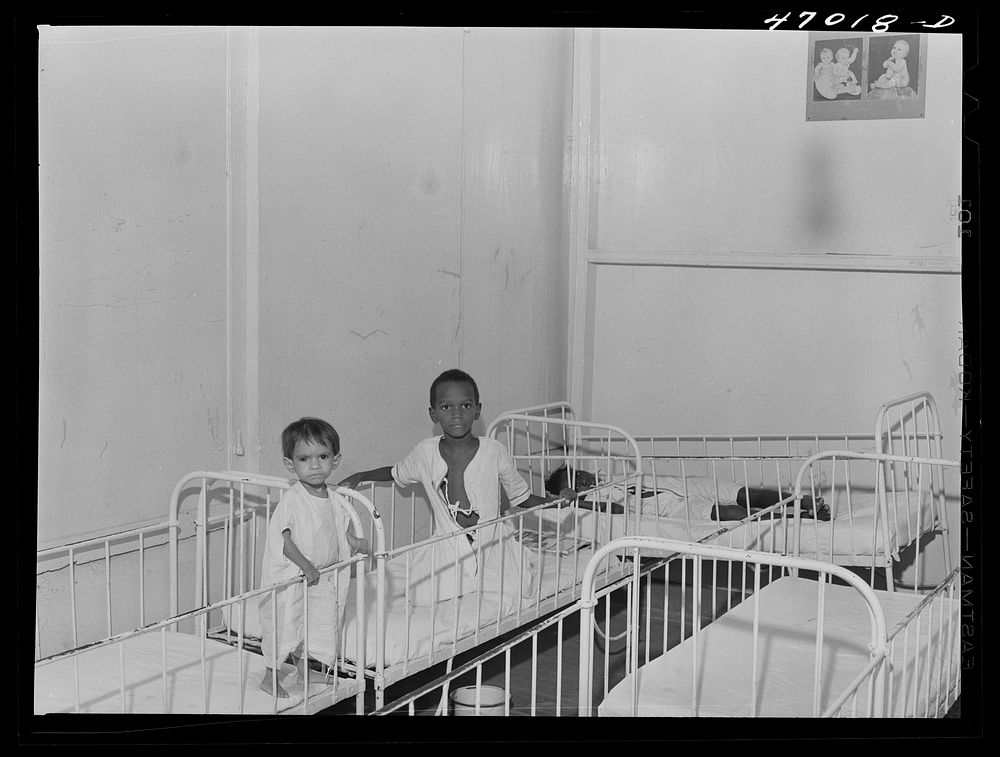 [Untitled photo, possibly related to: Frederiksted, Saint Croix, Virgin Islands. Child on the left, in the children's ward…
