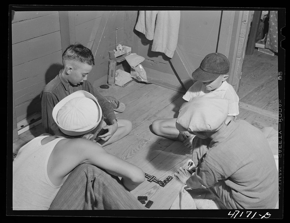 French village, a small settlement on Saint Thomas Island, Virgin Islands. Boys playing dominoes in one of the houses.…