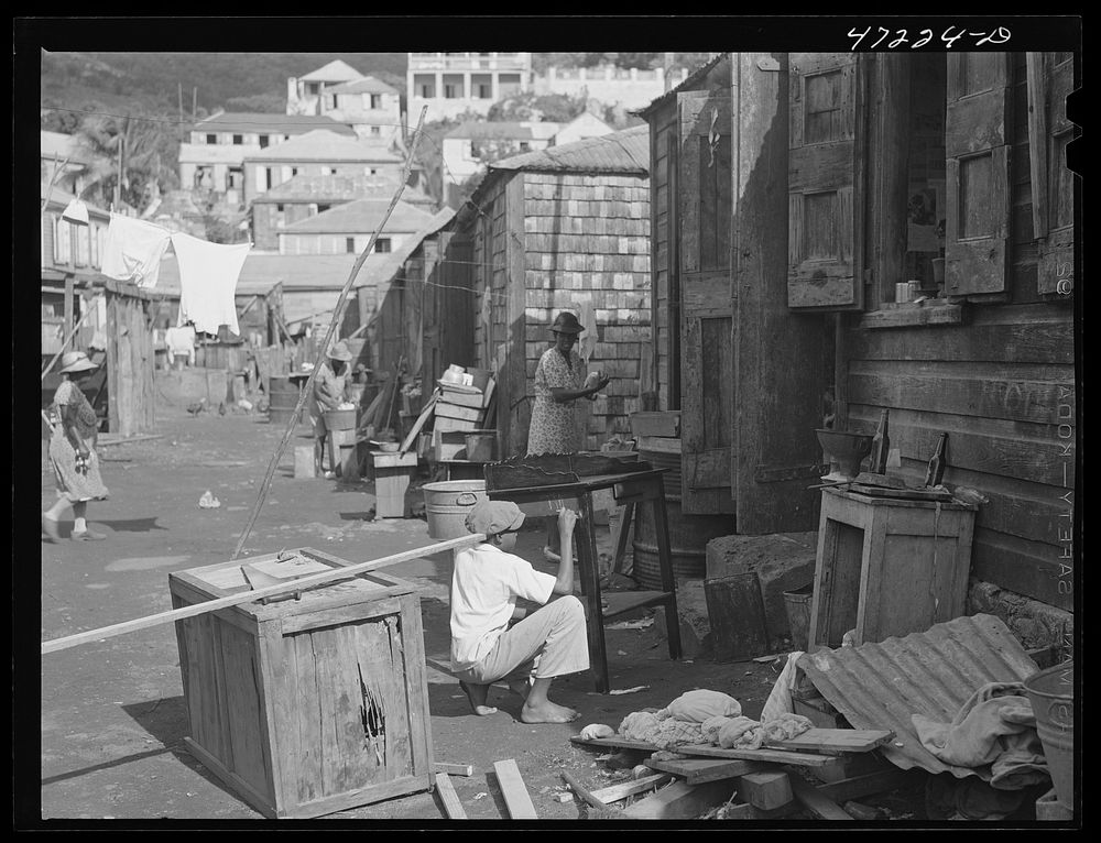 Charlotte Amalie, Saint Thomas Island, Virgin Islands. Painting furniture and cleaning house in a slum section. Sourced from…