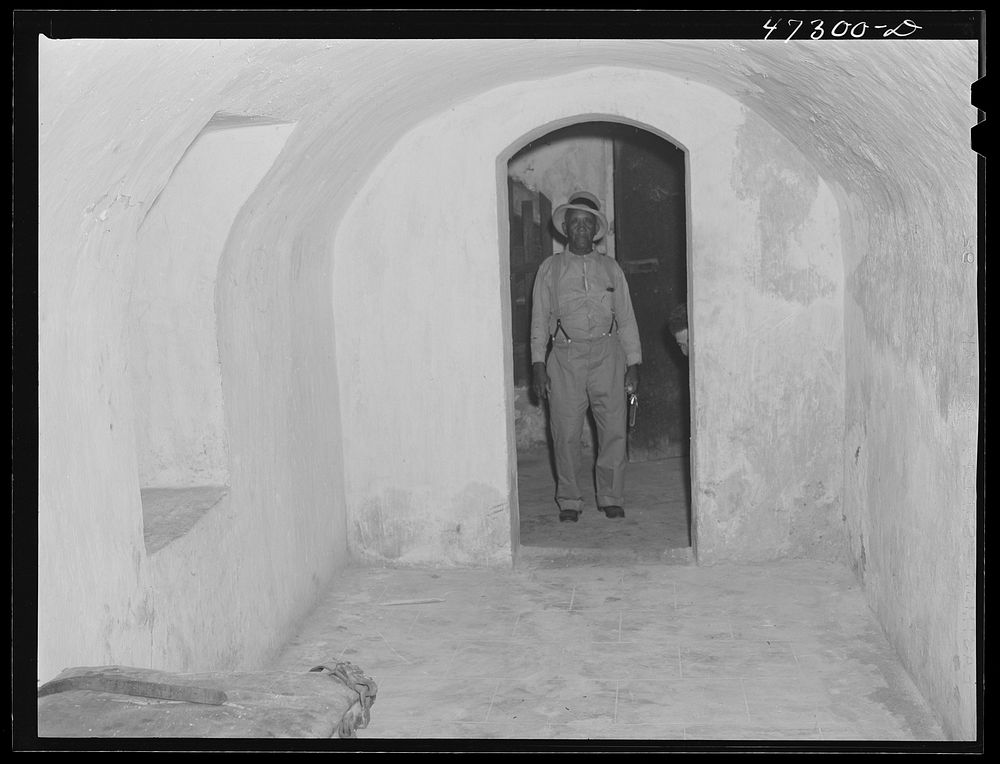 Charlotte Amalie, Saint Thomas Island, Virgin Islands. The prison warden in the doorway of the solitary dungeon at the…