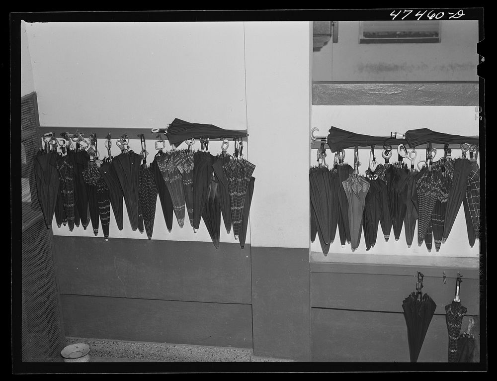 Santurce, Puerto Rico. These umbrellas were carried to work by women who are employed by the Rodriguez needlework factory.…