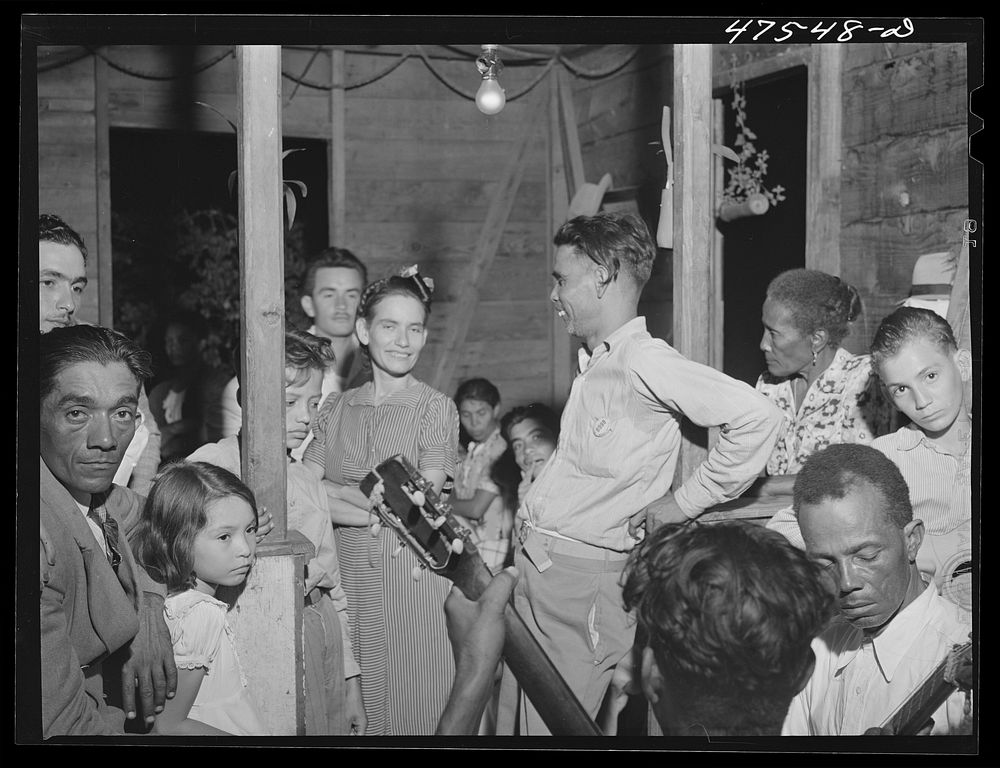 Guanica, Puerto Rico (vicinity). At a Three Kings' eve party in a tenant farmer's home in the sugar country. Sourced from…
