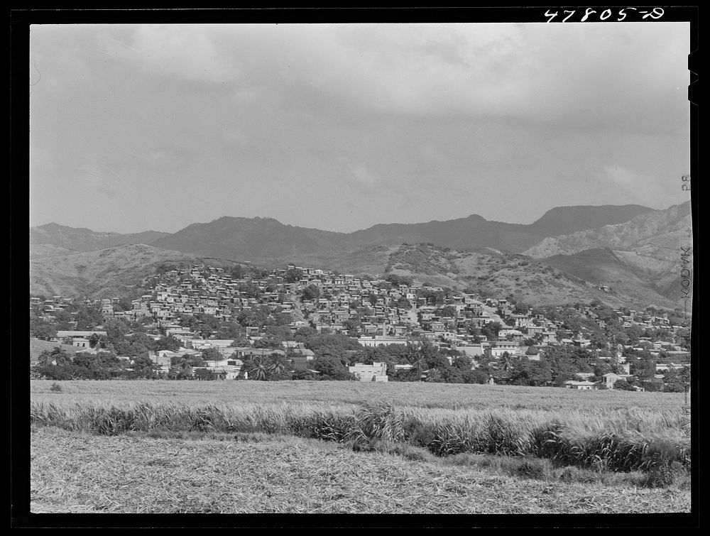 [Untitled photo, possibly related to: Yauco, Puerto Rico. The town, with slums sprawled on the hillside]. Sourced from the…