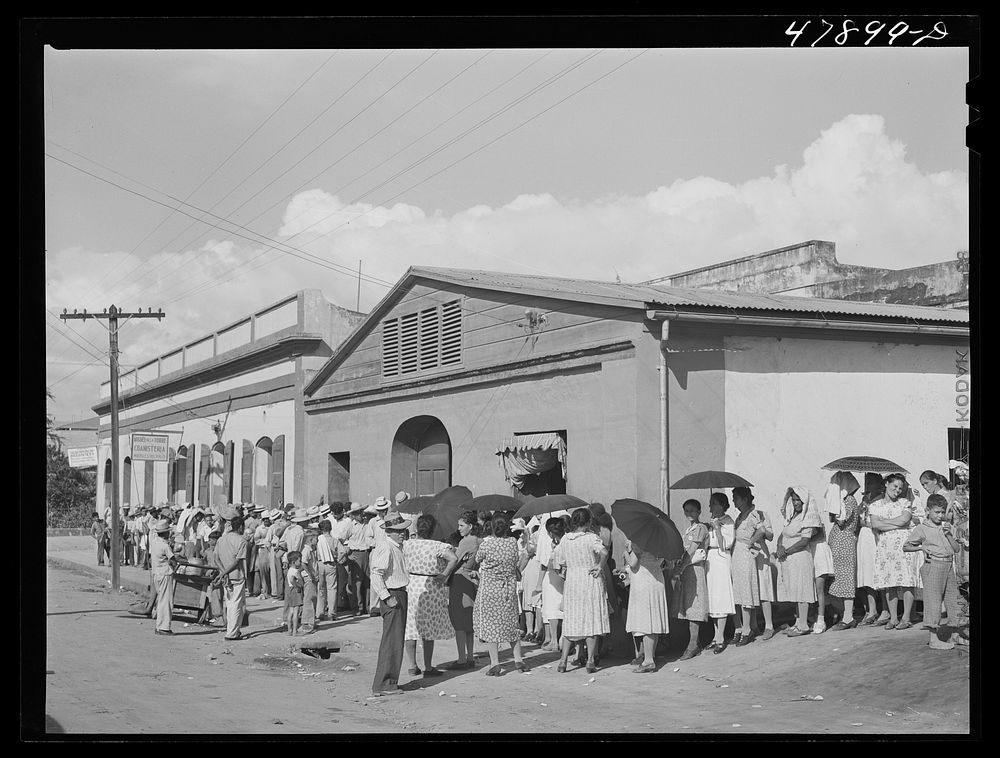 Cabo Rojo, Puerto Rico. Waiting in line to get surplus commodities. They were distributing fatback and meal. Sourced from…