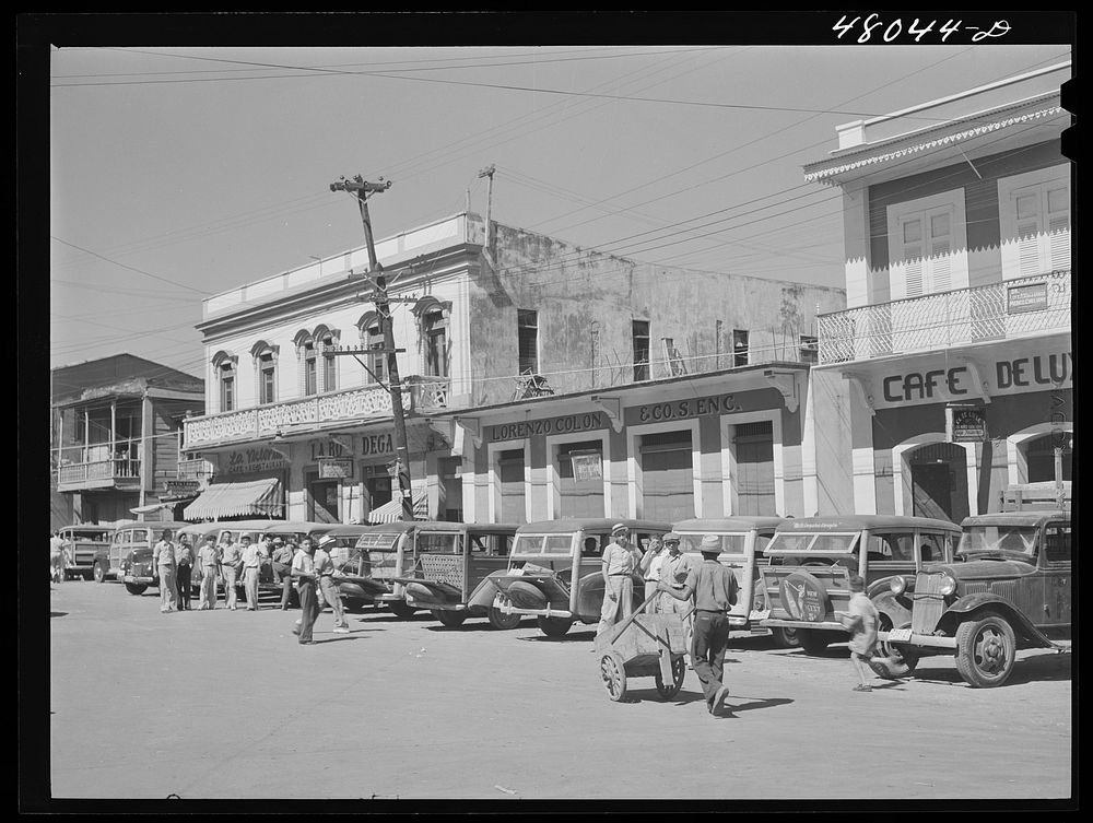 Arecibo, Puerto Rico. A row of station wagons or "publicos" waiting for loads and passengers. Sourced from the Library of…
