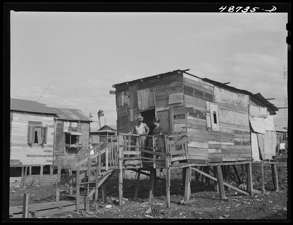 [Untitled photo, possibly related to: San Juan, Puerto Rico. El Fangitto, the slum area. The sign says the home is for…