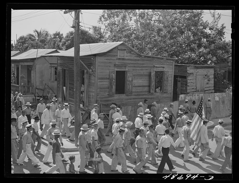 Yabucoa, Puerto Rico (vicinity). Procession of sugar strikers through a small town. Sourced from the Library of Congress.