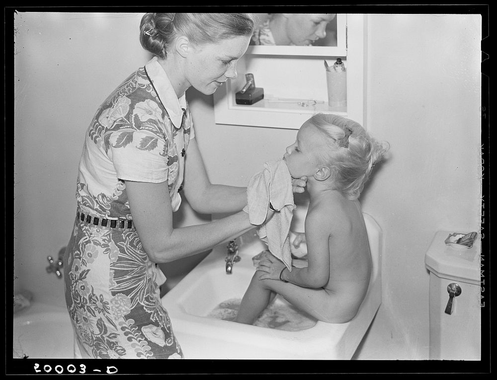 Mother and child in bathroom of new home. Greenbelt, Maryland. Sourced from the Library of Congress.