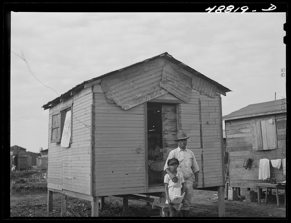 San Juan, Puerto Rico. Worker from the naval base in San Juan who lives in this house in El Fangitto, the slum area. Sourced…